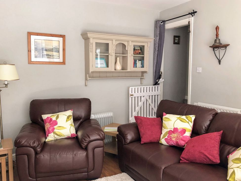 A living room with a sofa and armchairs at Wedgewood Cottage, Middleham
