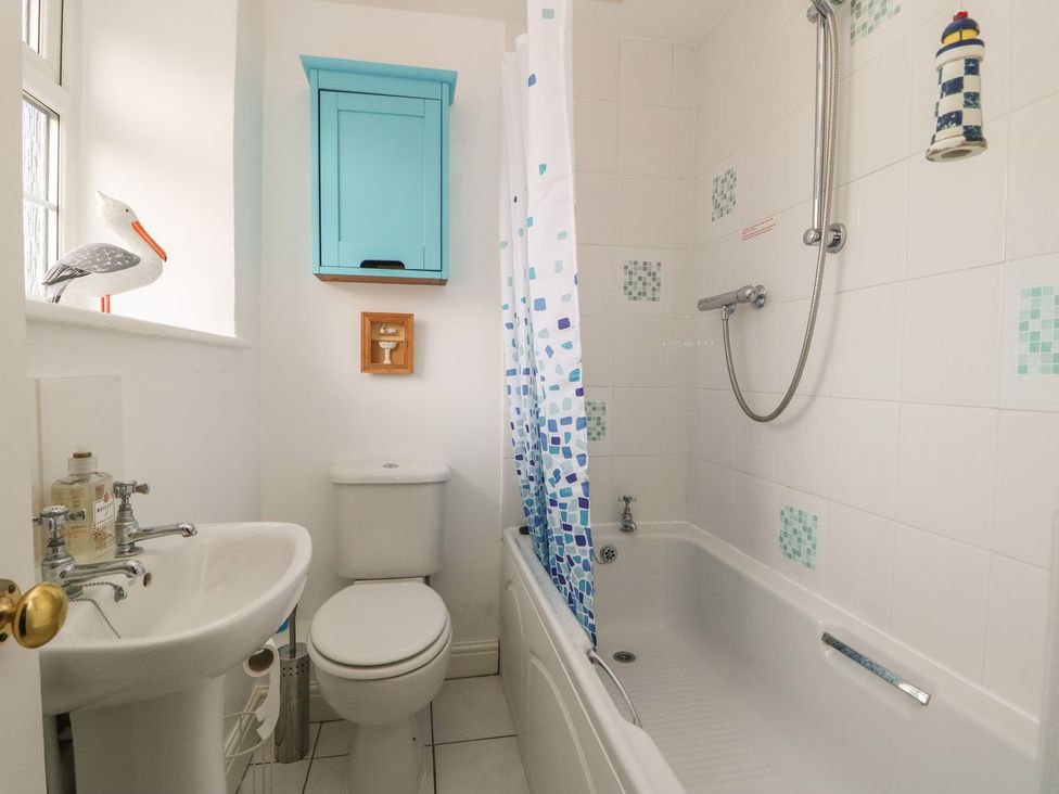 A bathroom with a bathtub and sink at Wedgewood Cottage in Middleham