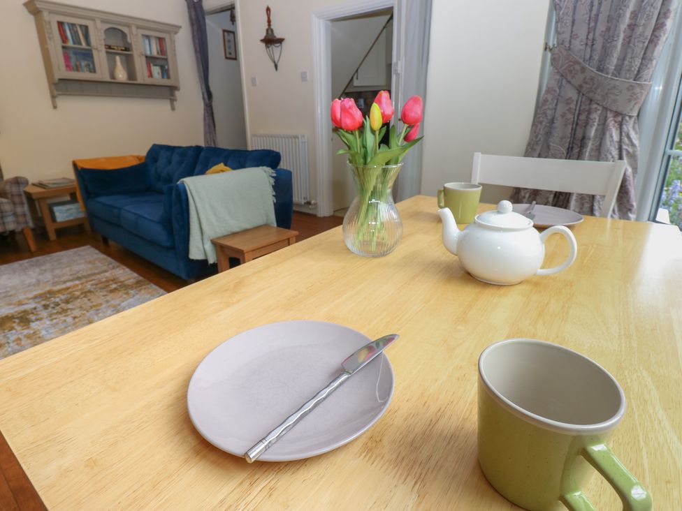 A dining room with a table set for tea at Wedgewood Cottage in Middleham