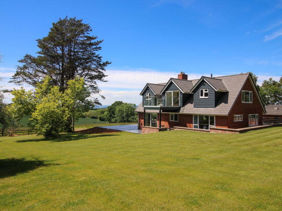 A house with a lawn and trees at Westington Hall Hatfield near Bromyard