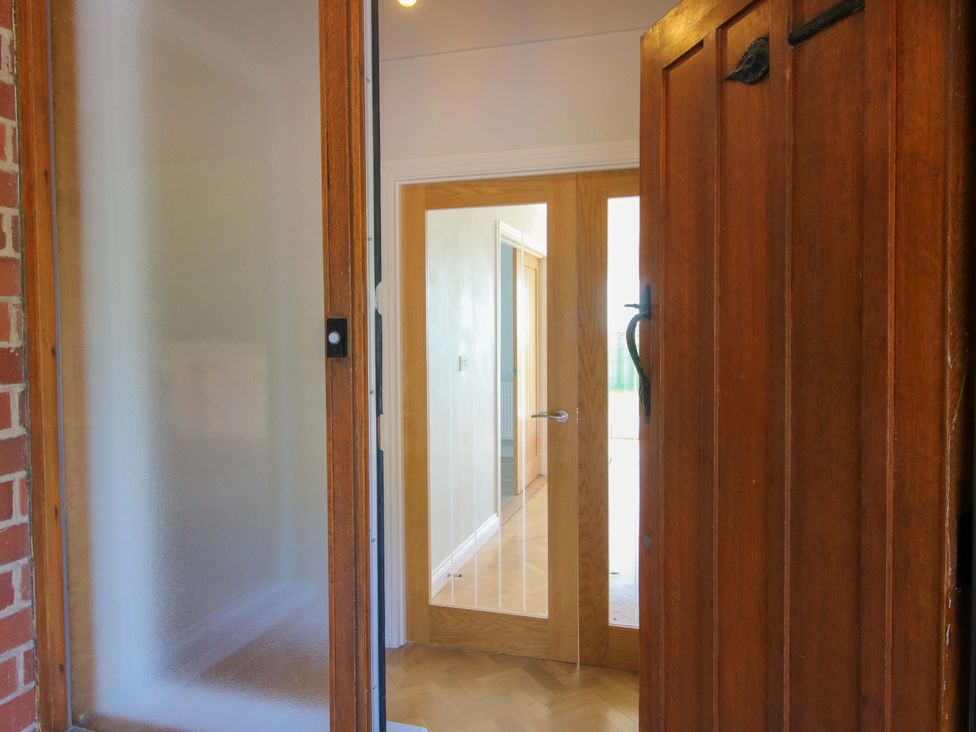 An entrance with wooden doors and frosted glass at Westington Hall in Hatfield near Bromyard
