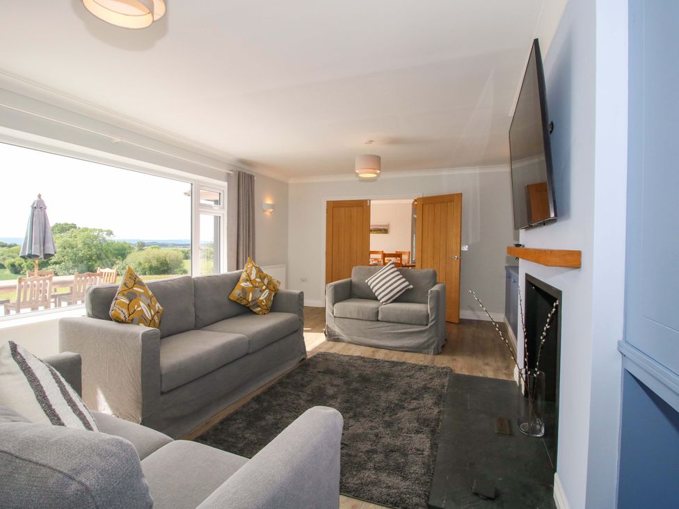 A living room with a sofa and television at Westington Hall in Hatfield near Bromyard