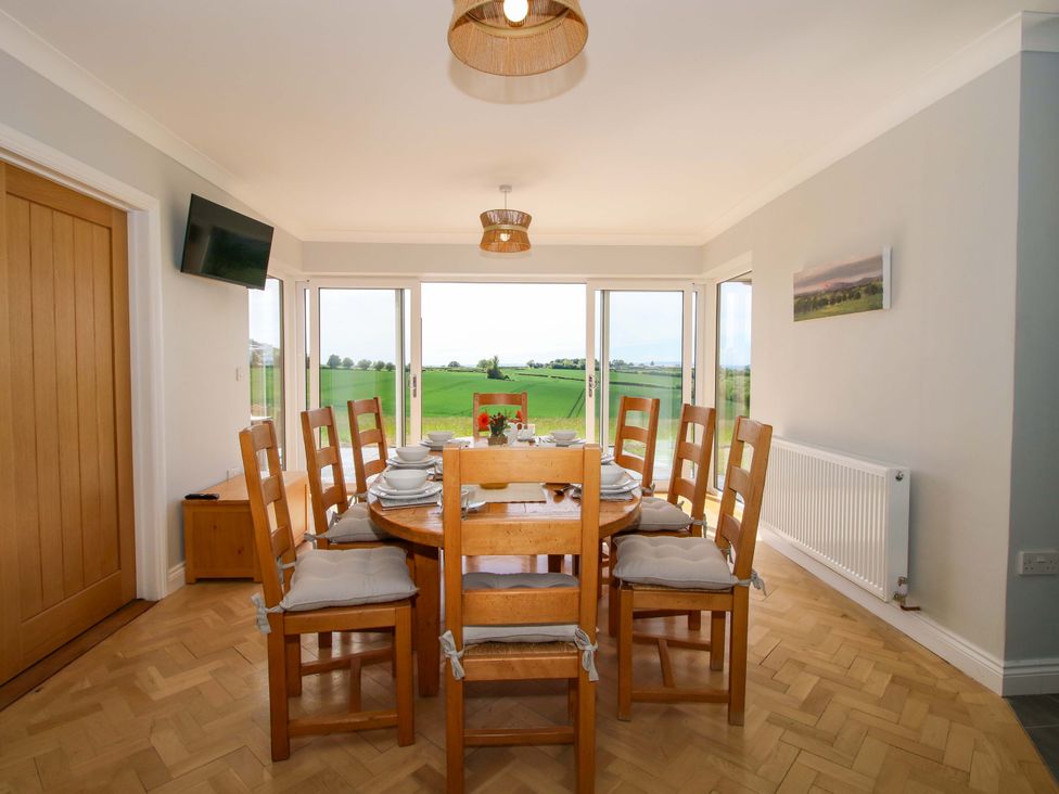 A dining room with a table and chairs at Westington Hall Hatfield near Bromyard