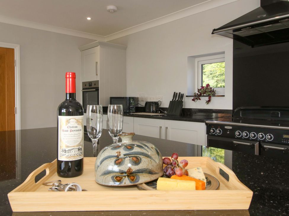 A kitchen with a tray holding wine, glasses, cheese, and grapes at Westington Hall in Hatfield near Bromyard