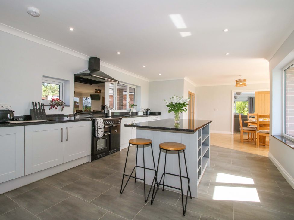 A kitchen with countertop and stools at Westington Hall in Hatfield near Bromyard