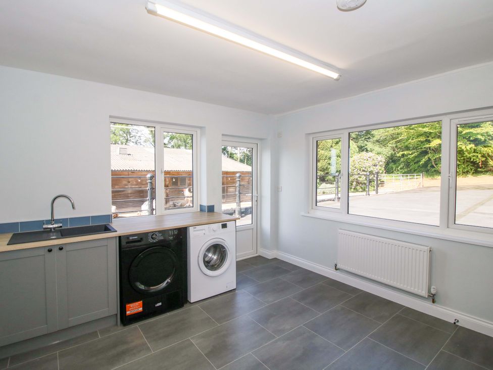 A utility room with a washing machine and dryer at Westington Hall Hatfield near Bromyard