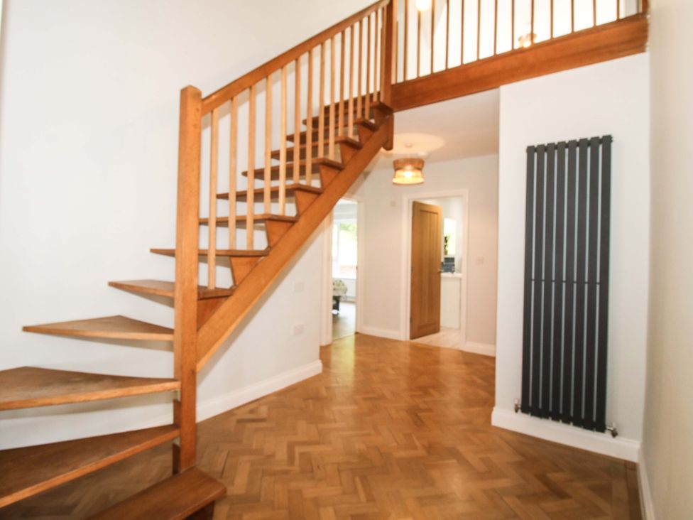 A hallway with a staircase and a radiator at Westington Hall near Hatfield