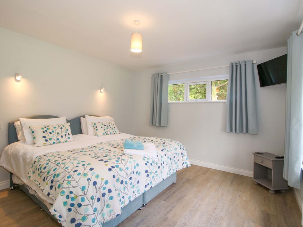 A bedroom with two beds and a television at Westington Hall in Hatfield near Bromyard