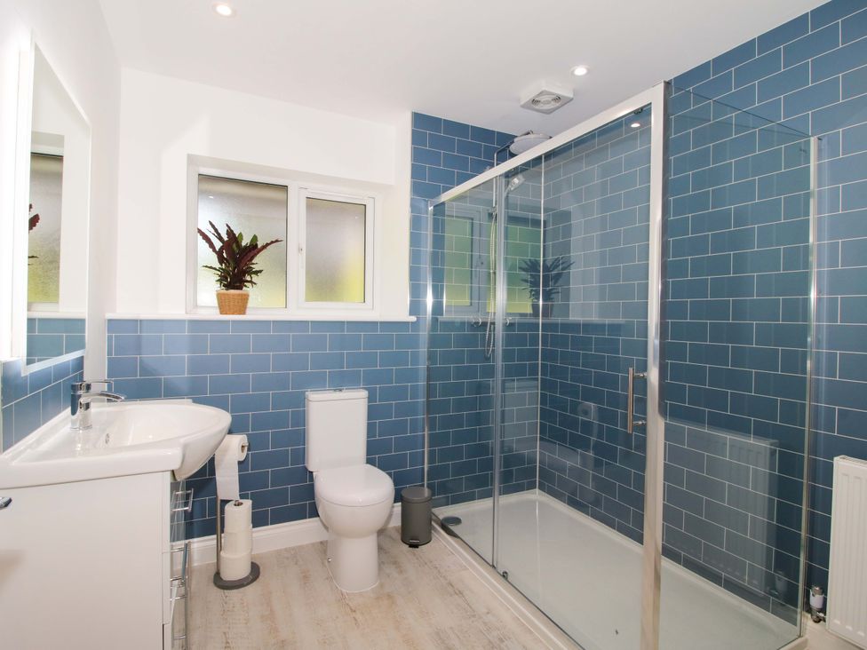A bathroom with a sink, toilet, and shower at Westington Hall Hatfield near Bromyard