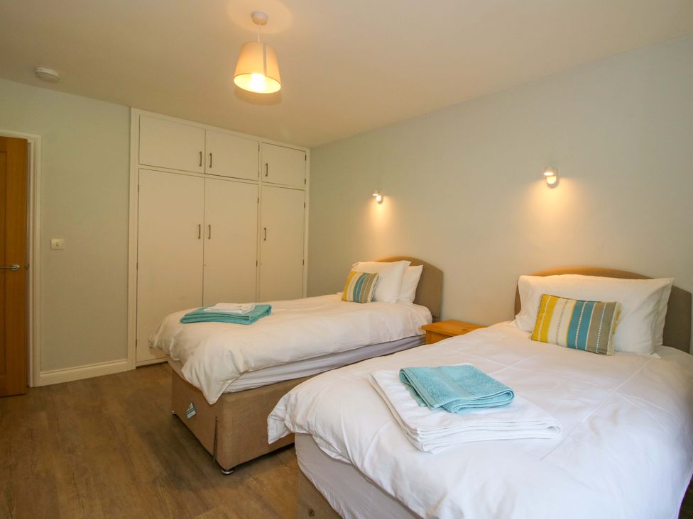 A bedroom with two single beds and wardrobe at Westington Hall Hatfield near Bromyard