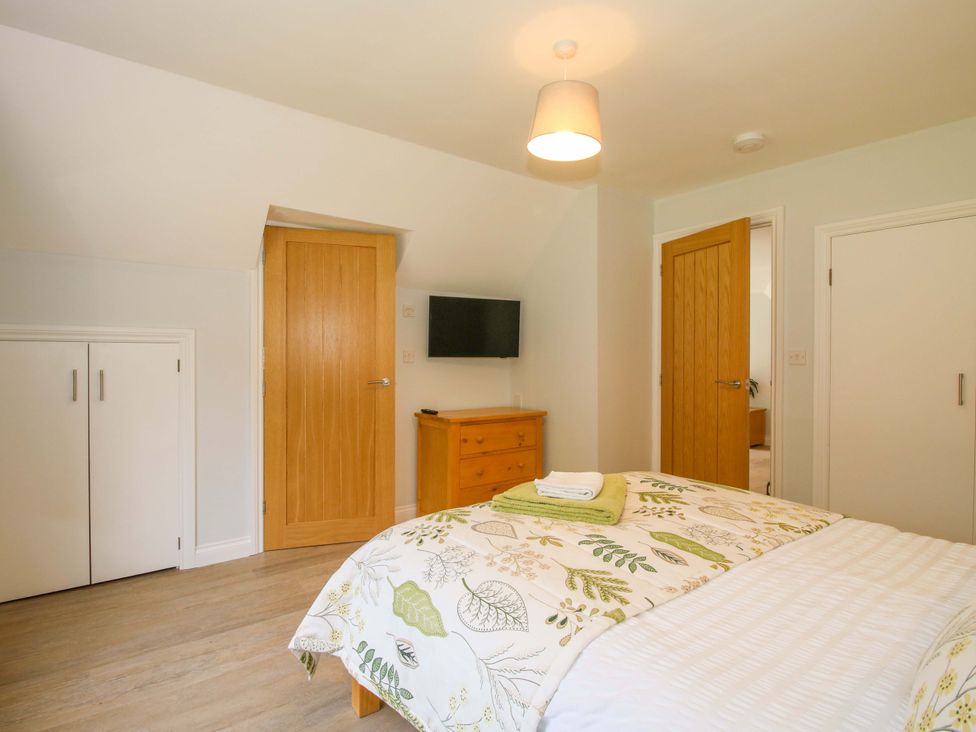 A bedroom with a bed and television at Westington Hall near Hatfield Bromyard
