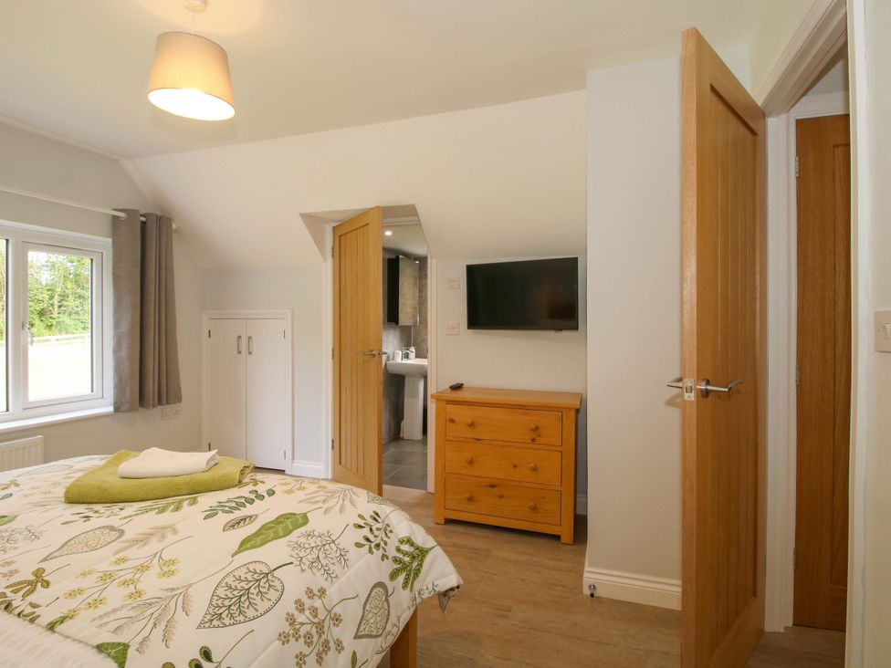 A bedroom with a double bed and a television at Westington Hall in Hatfield near Bromyard