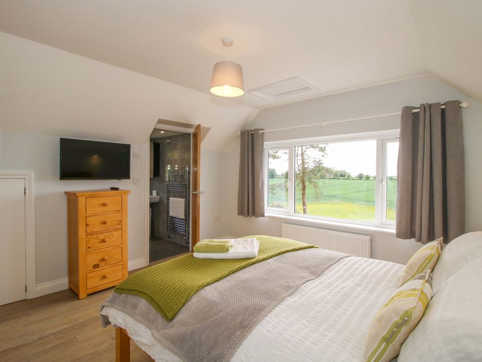 A bedroom with a bed and dresser at Westington Hall Hatfield near Bromyard