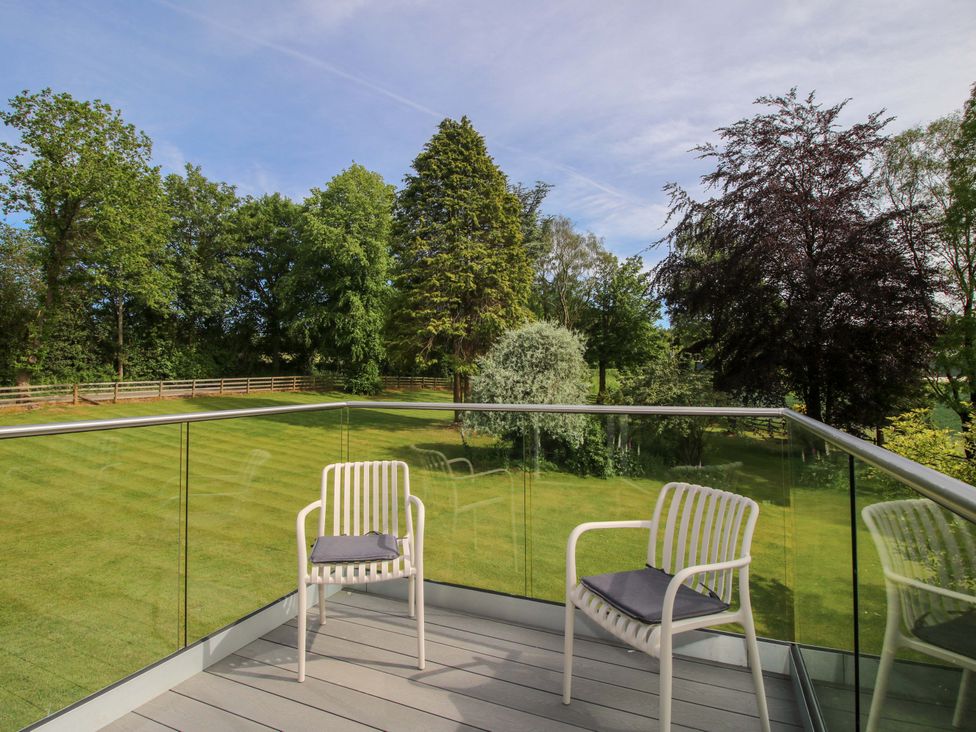 An outdoor area with chairs on a deck at Westington Hall Hatfield near Bromyard