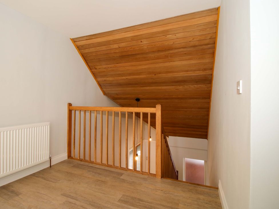 A staircase with wooden railing at Westington Hall Hatfield near Bromyard