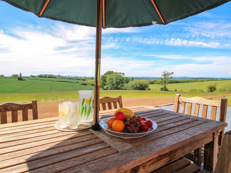 A table with fruits and drinks under an umbrella at Westington Hall Hatfield near Bromyard