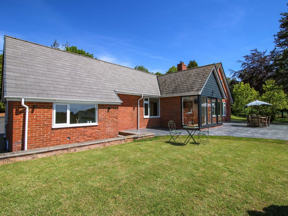 A house with a garden and patio furniture at Westington Hall Hatfield near Bromyard