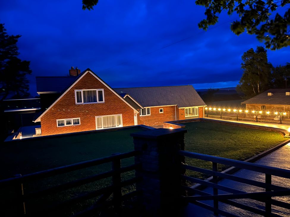 A house with outdoor lighting and a driveway at Westington Hall in Hatfield near Bromyard