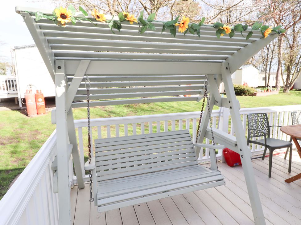 A swing with floral decoration at Sunflower Retreat, Caravan 61