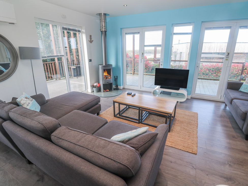 A living room with a fireplace and television at Warleggan in Redruth