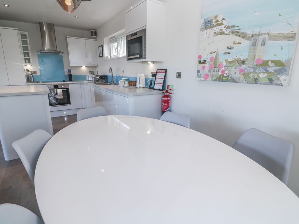 A kitchen with a table and chairs at Warleggan in Redruth