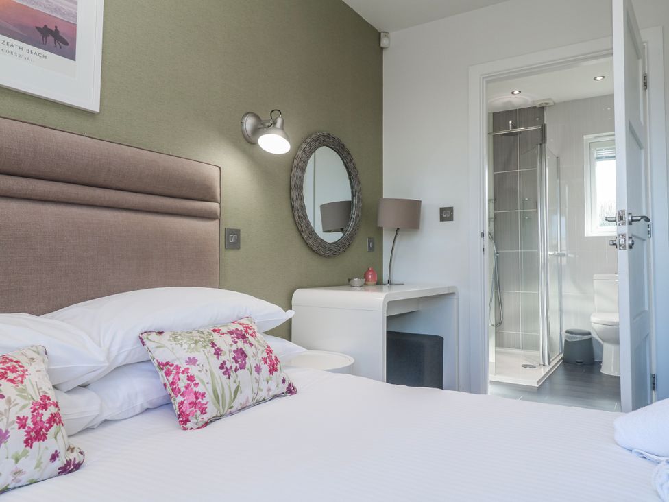 A bedroom with a bed and an ensuite bathroom at Warleggan in Redruth