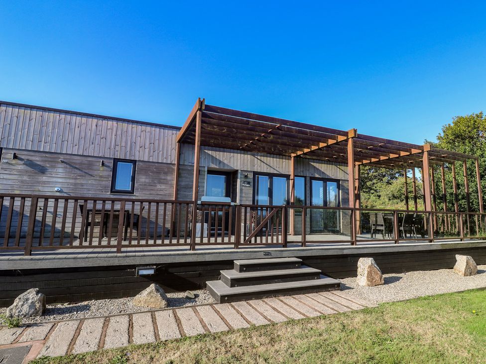 An outdoor area with a deck and pergola at Warleggan in Portreath