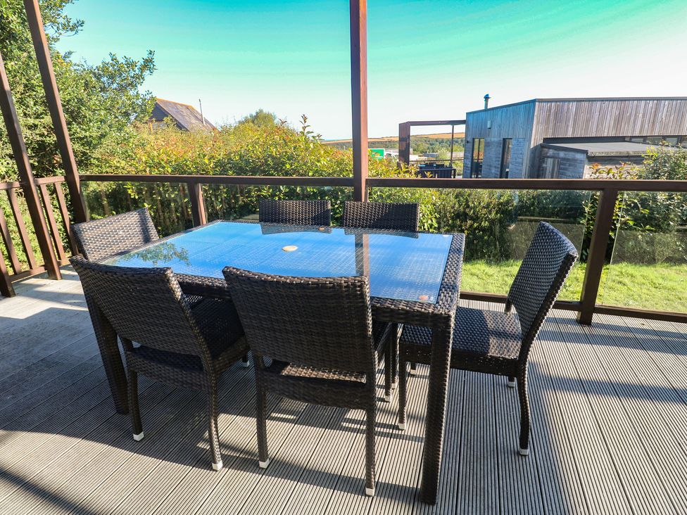 An outdoor dining area with a table and chairs at Warleggan, Portreath