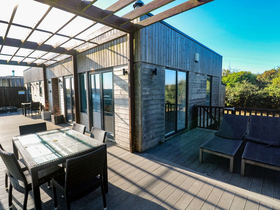 An outdoor space with a table and chairs at Warleggan in Portreath