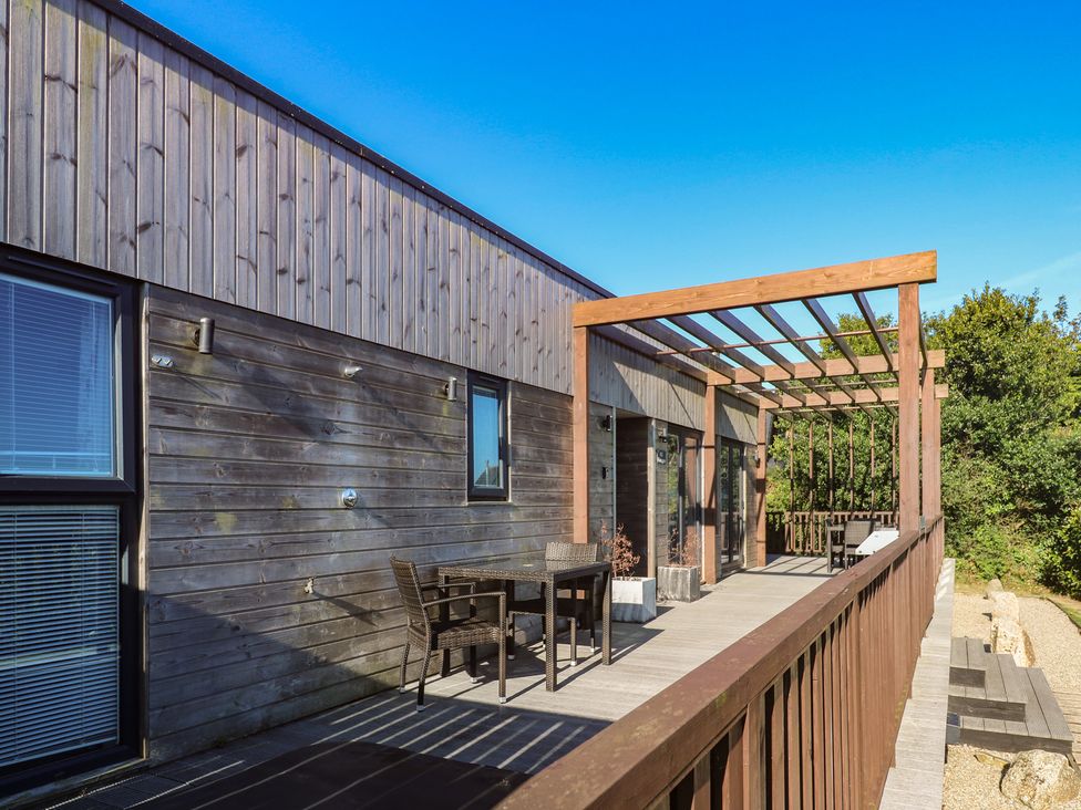 An outdoor area with a deck, table and chairs at Warleggan, Portreath