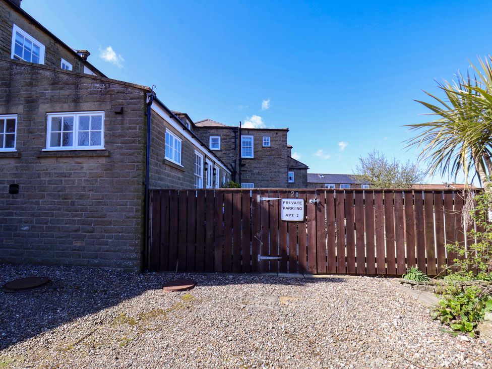 An outdoor area with a wooden gate and sign at Annie's Place in Sleights