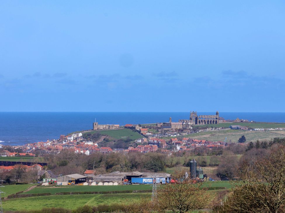 A seaside view with buildings and ruins at Annie's Place in Sleights