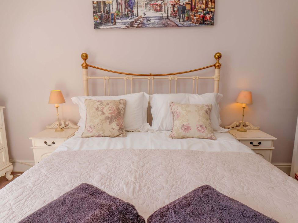 A bedroom with a bed and bedside lamps at Annie's Place in Sleights