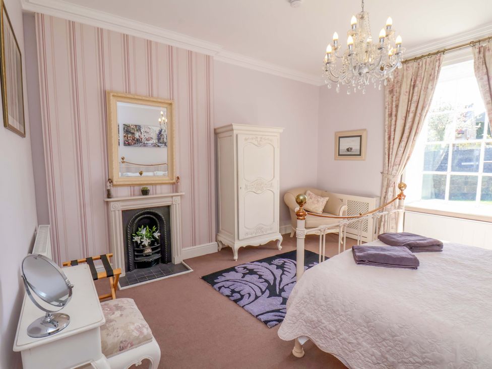 A bedroom with a bed and wardrobe at Annie's Place in Sleights