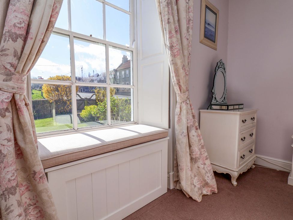 A bedroom with a window and dressing table at Annie's Place in Sleights