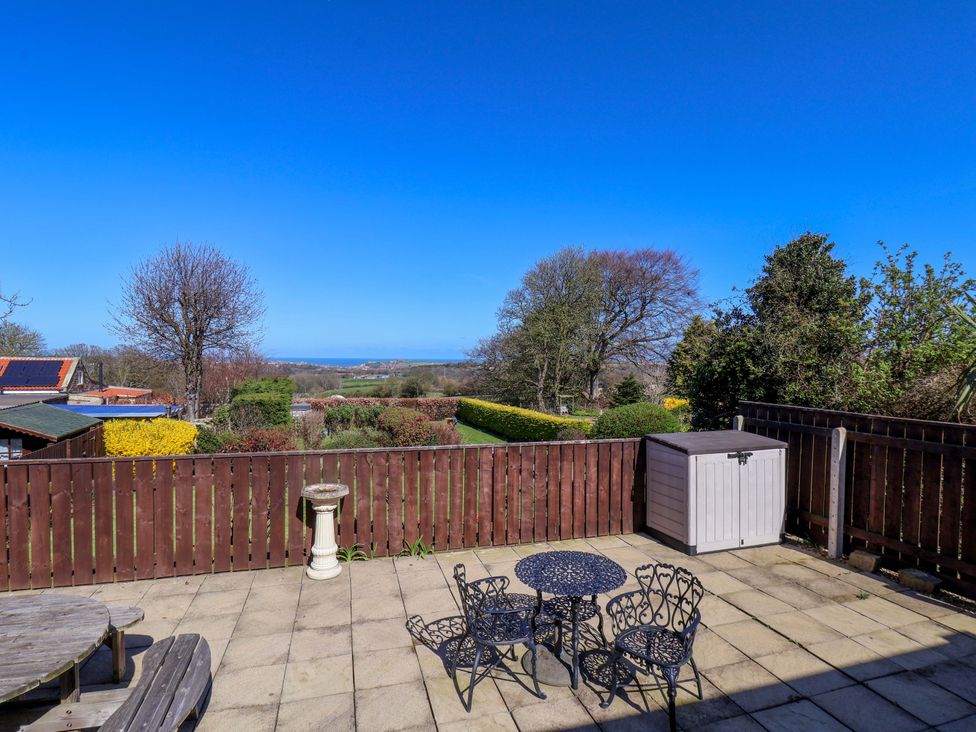 A garden with a table and chairs at Annie's Place in Sleights