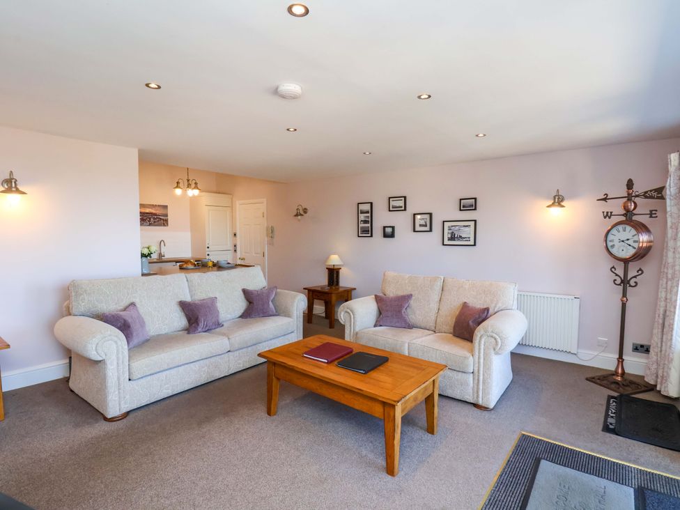 A living room with sofas and a table at Annie's Place in Sleights