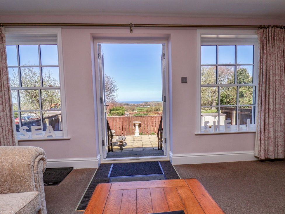 A living room with a view of the sea at Annie's Place in Sleights