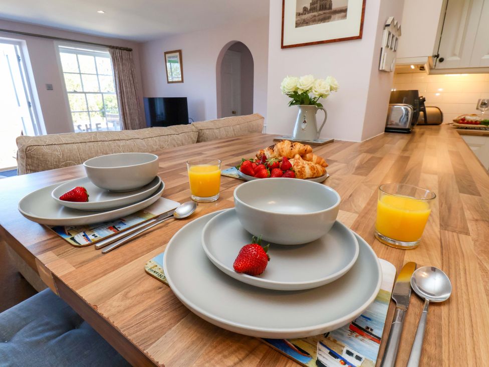 A dining table set with plates, bowls, and juice at Annie's Place in Sleights