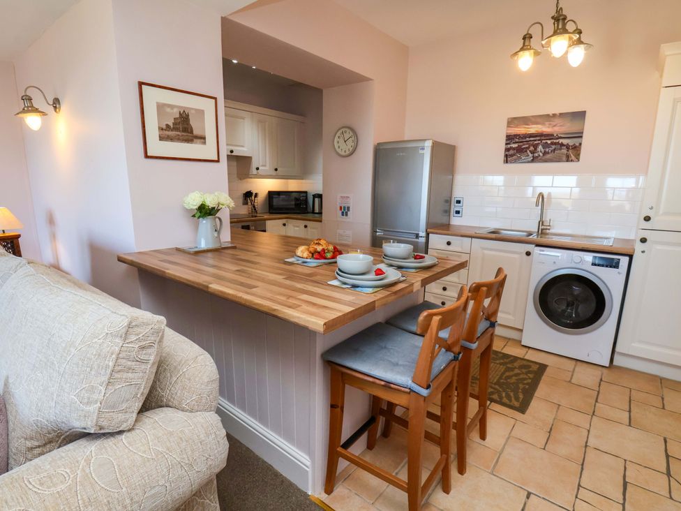 A kitchen with a countertop and stools at Annie's Place in Sleights