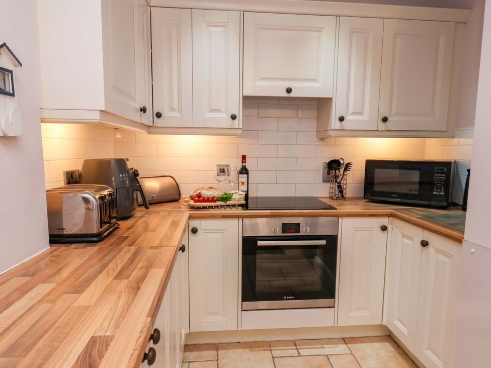 A kitchen with appliances and a countertop at Annie's Place in Sleights