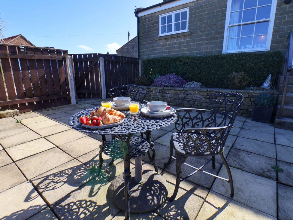 An outdoor patio with a table set for breakfast at Annie's Place in Sleights