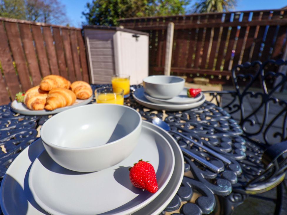 An outdoor dining area with dishes and croissants at Annie's Place Sleights