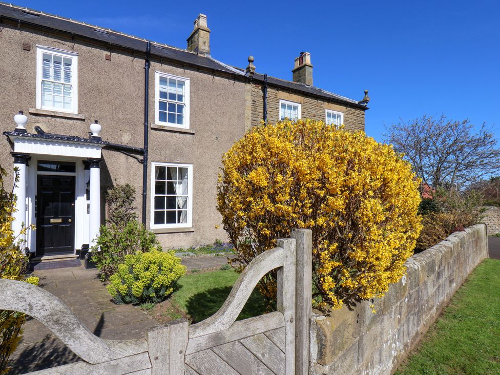 A house with a front gate and bush at Annie's Place in Sleights