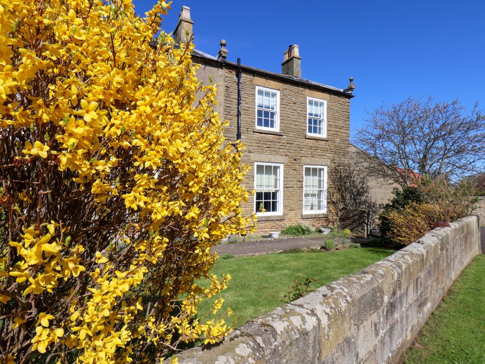 A house with flowers in the garden at Annie's Place Sleights