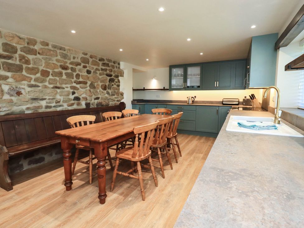 A kitchen with a dining table and chairs at Ragged Hall Barn Settle