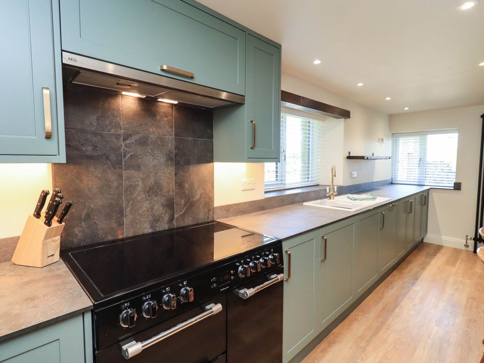 A kitchen with cabinets and countertop at Ragged Hall Barn Settle