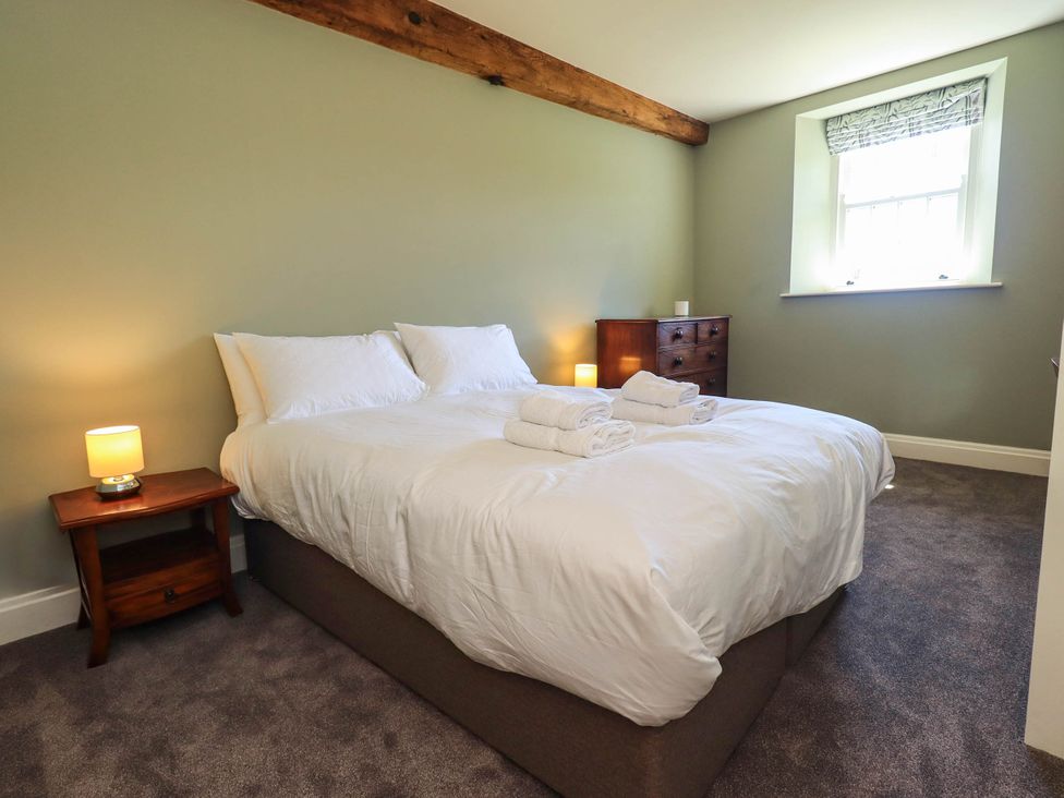 A bedroom with a bed and chest of drawers at Ragged Hall Barn in Settle