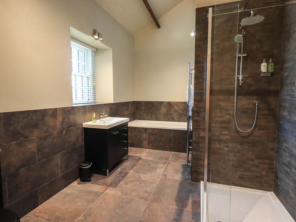 A bathroom with a sink, shower and bathtub at Ragged Hall Barn in Settle