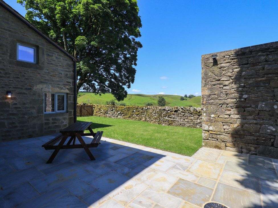 An outdoor area with a bench and grass at Ragged Hall Barn Settle